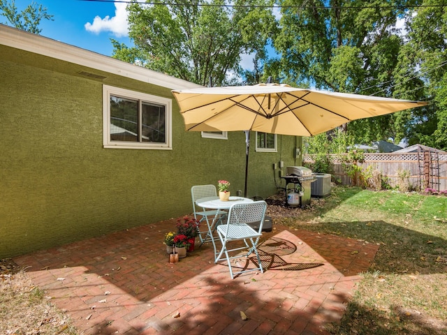 view of patio / terrace with a grill and cooling unit