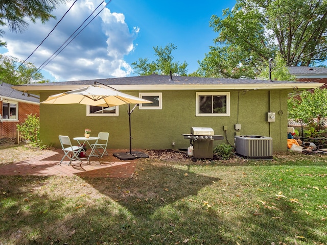 back of house with a yard, a patio area, and central air condition unit