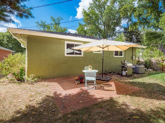 rear view of property featuring a patio and central air condition unit