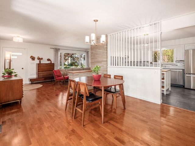 dining area featuring a notable chandelier and light hardwood / wood-style floors