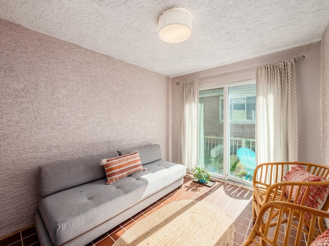 living area featuring tile patterned floors and a textured ceiling