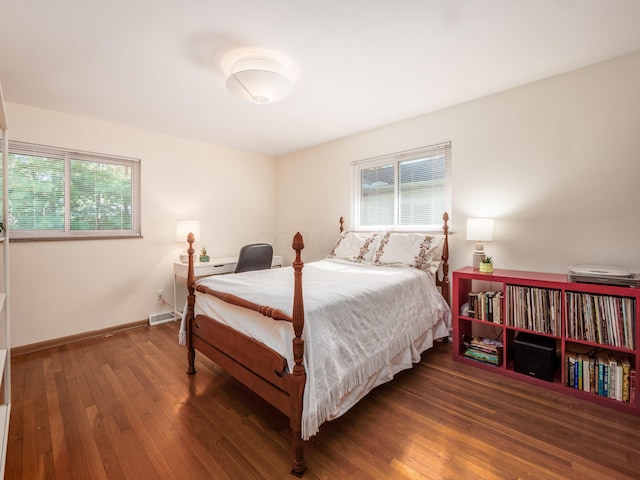 bedroom with dark hardwood / wood-style flooring