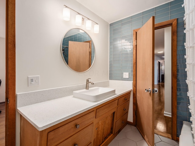 bathroom with tile patterned floors, vanity, and tile walls