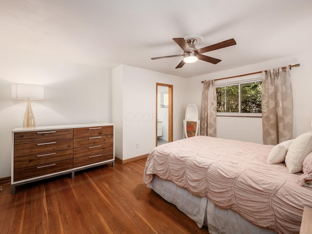 bedroom with ensuite bathroom, ceiling fan, and dark wood-type flooring