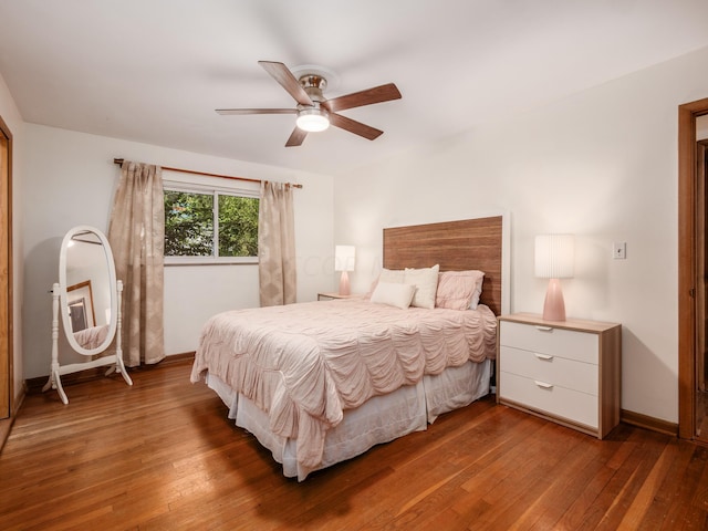 bedroom featuring ceiling fan and dark wood-type flooring