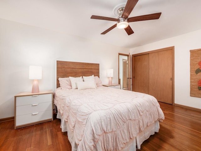 bedroom with dark hardwood / wood-style flooring, a closet, and ceiling fan