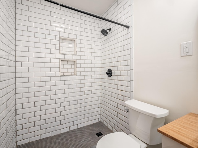 bathroom featuring toilet and tiled shower