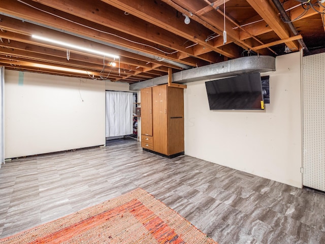 basement with hardwood / wood-style flooring