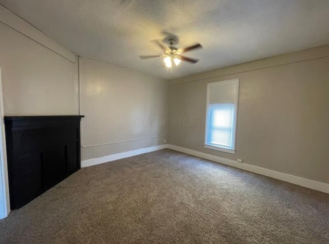 unfurnished living room with carpet, ceiling fan, and a textured ceiling