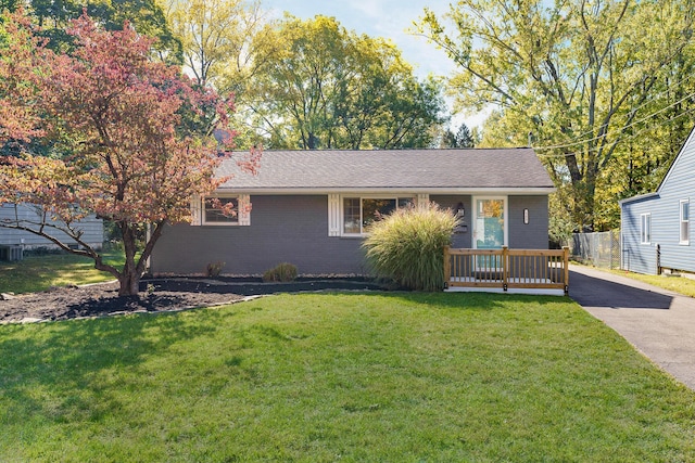 single story home featuring a front yard and covered porch