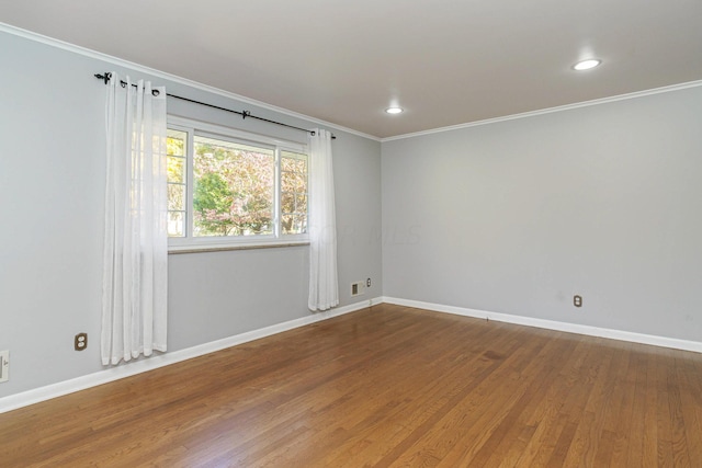 unfurnished room featuring ornamental molding and hardwood / wood-style flooring