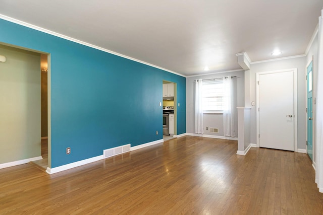 unfurnished bedroom featuring wood-type flooring and crown molding