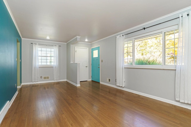 empty room featuring hardwood / wood-style flooring and ornamental molding