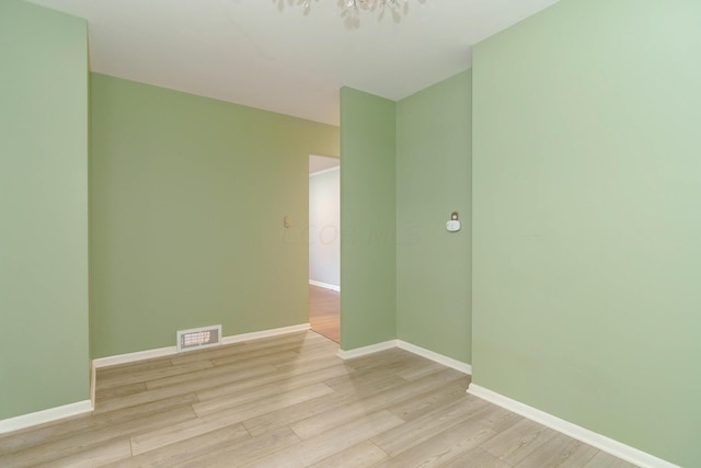 spare room with light wood-type flooring