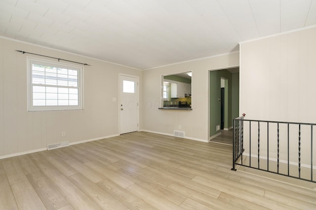 interior space featuring crown molding and light hardwood / wood-style floors