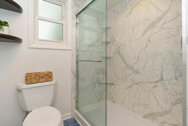 bathroom featuring tile patterned flooring, toilet, and walk in shower