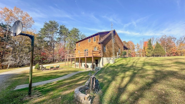 view of side of property with a deck and a yard