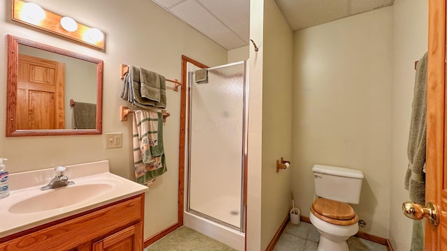 bathroom with tile patterned flooring, toilet, vanity, and walk in shower