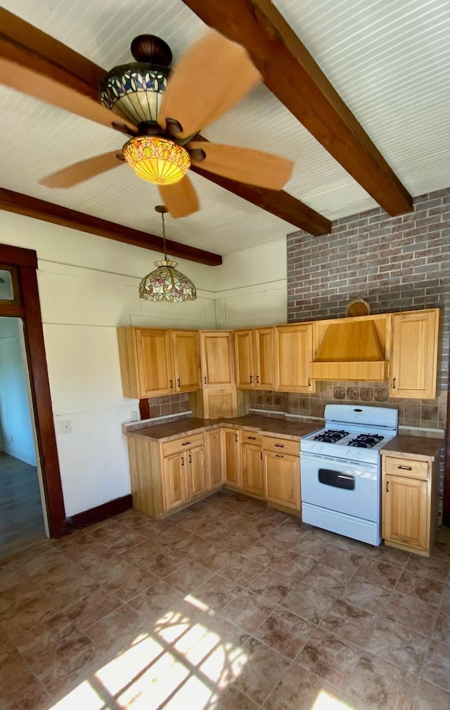 kitchen featuring pendant lighting, premium range hood, ceiling fan, tasteful backsplash, and white gas stove