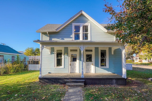 bungalow-style house featuring covered porch and a front yard