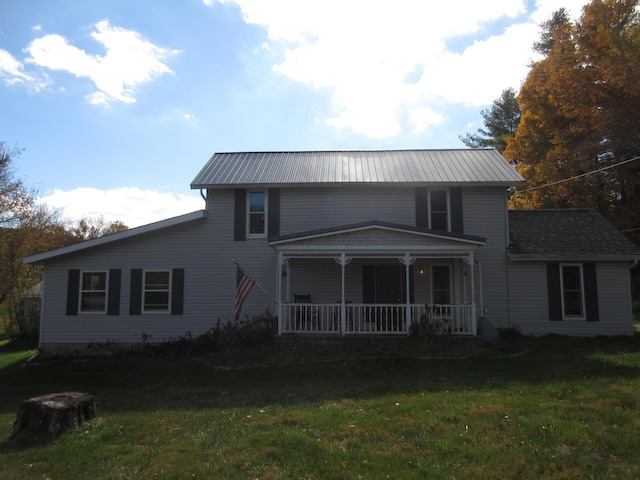 view of front of home featuring a front yard and covered porch