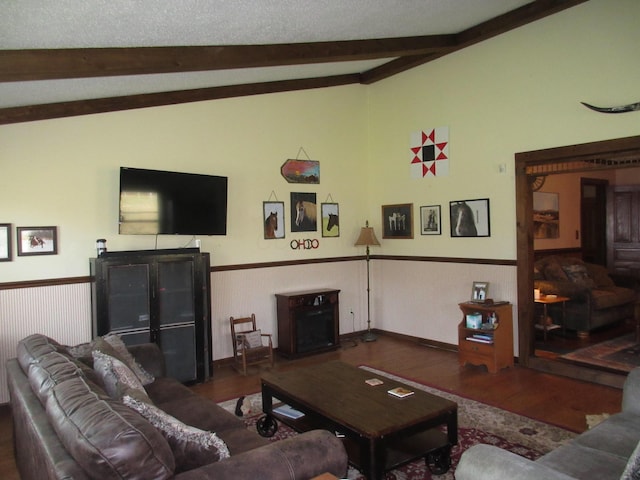 living room featuring a textured ceiling, vaulted ceiling with beams, and dark hardwood / wood-style floors