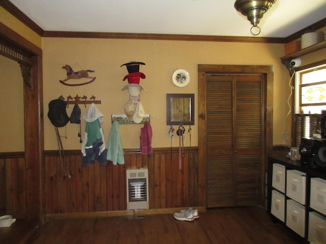 interior space featuring heating unit, crown molding, wooden walls, and dark hardwood / wood-style floors