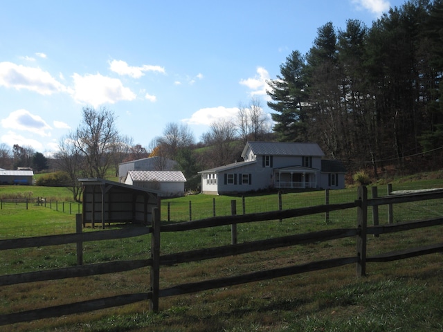 view of yard with an outbuilding and a rural view