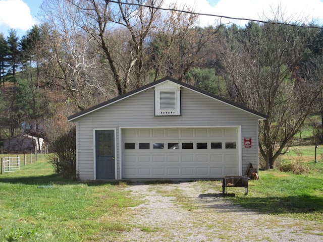 garage featuring a lawn