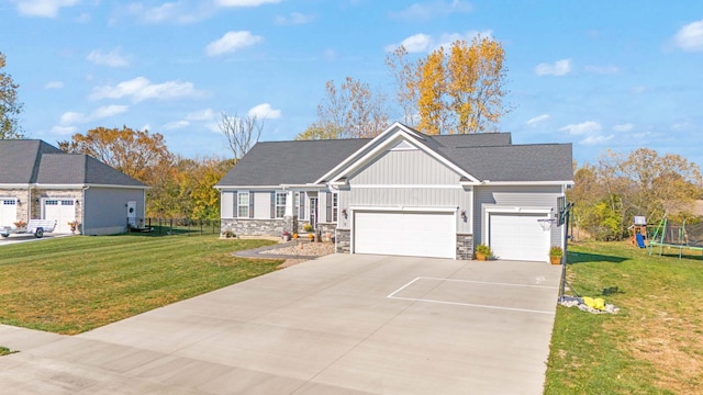 view of front of property featuring a trampoline, a garage, and a front lawn