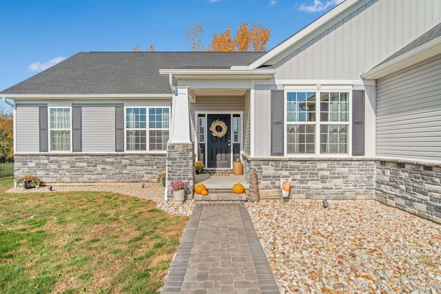 doorway to property with a yard