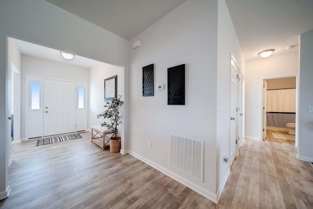 entryway featuring a textured ceiling and light hardwood / wood-style floors