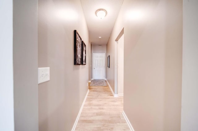 corridor with light wood-type flooring