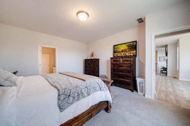 bedroom featuring light carpet