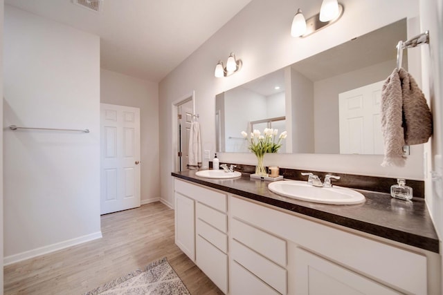 bathroom featuring vanity and wood-type flooring