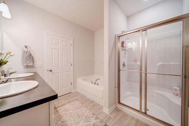 bathroom featuring hardwood / wood-style flooring, vanity, and independent shower and bath