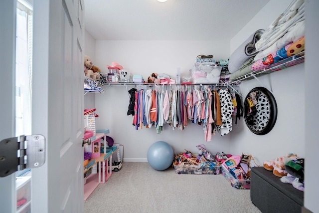 walk in closet featuring carpet