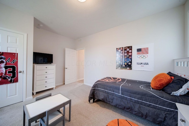 bedroom with light colored carpet