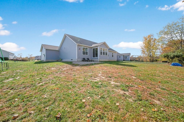 rear view of property with a lawn