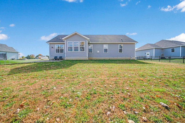 rear view of property with a lawn