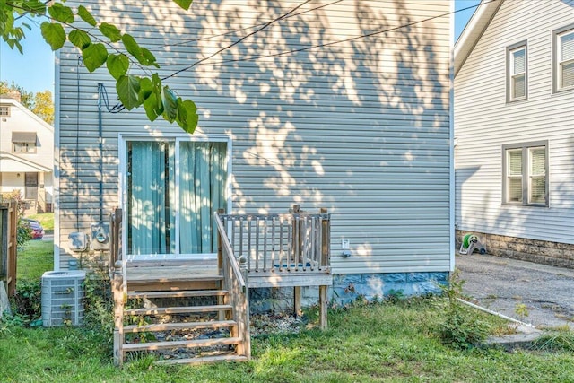 back of house with central AC