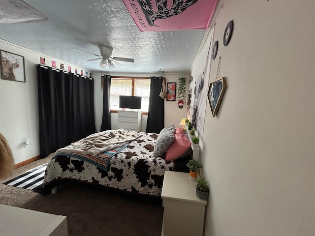 carpeted bedroom with a textured ceiling and ceiling fan