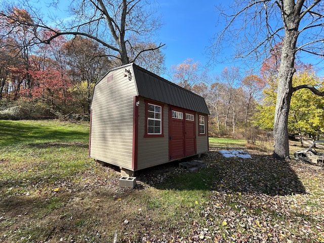 view of outdoor structure featuring a lawn