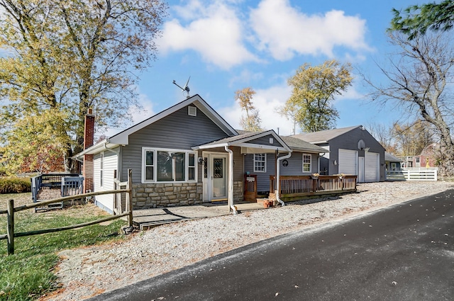 514 Mount Vernon Ave, Thornville, OH 43076 - bungalow featuring a chimney, stone siding, and an attached garage