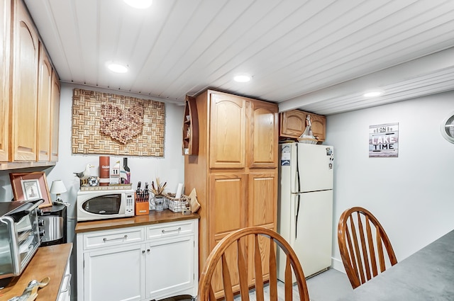 kitchen featuring white appliances and wood counters