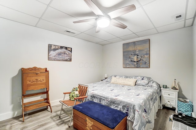 bedroom featuring a paneled ceiling, ceiling fan, and hardwood / wood-style flooring