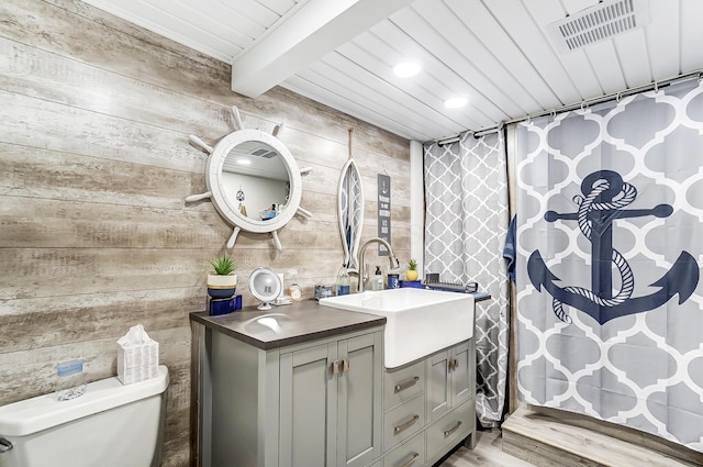 514 Mount Vernon Ave, Thornville, OH 43076 - bathroom with vanity, wooden walls, beamed ceiling, a shower with curtain, and wood finished floors