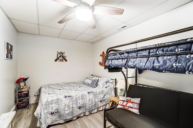 bedroom featuring a paneled ceiling, ceiling fan, and hardwood / wood-style flooring