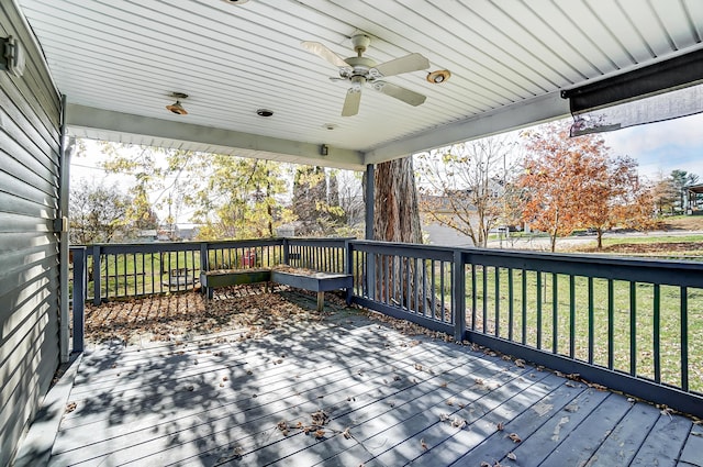 deck featuring a yard and ceiling fan