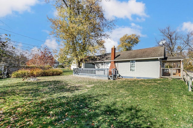 back of house with a lawn and a wooden deck